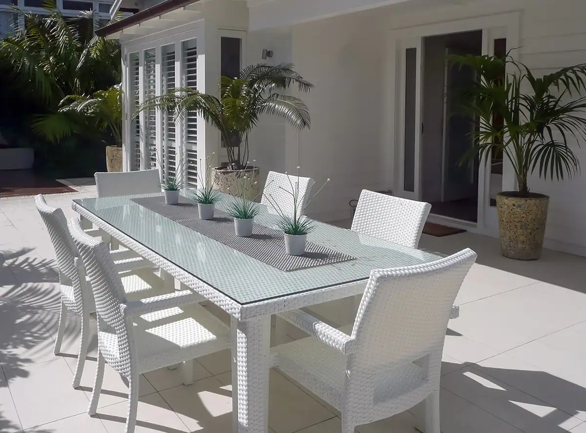 Outdoor dining area in Herne Bay with modern white furniture and feature pots.