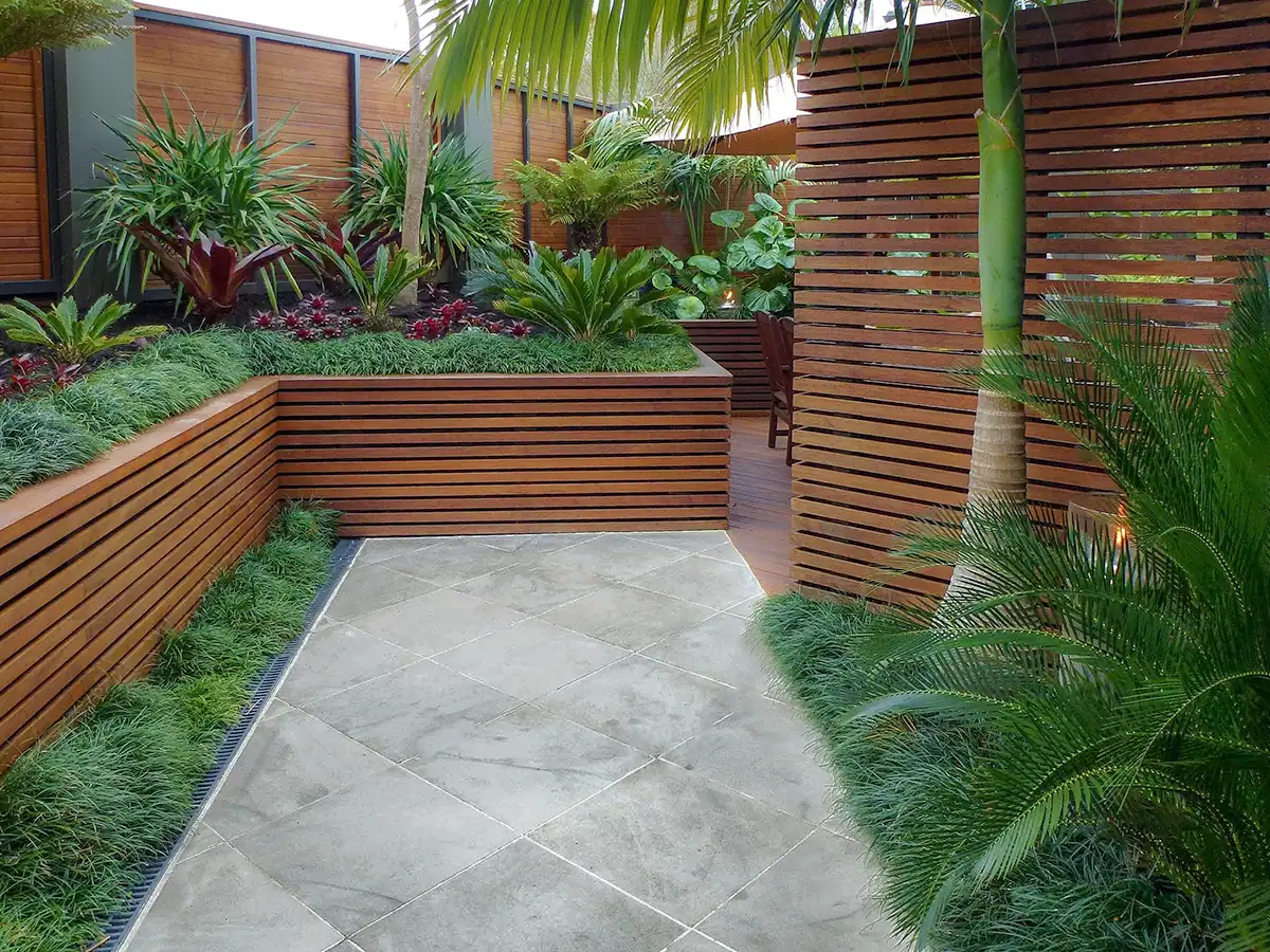 Birkenhead tiled entrance path with feature slat screen and timber clad retaining wall