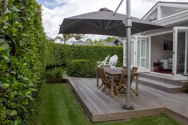 Cantilever umbrella attached to deck Sun umbrella providing shade in and Auckland garden.