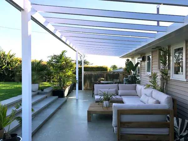 Modern pergola outdoor lounge design. White pergola structure over outdoor lounge designed for relaxing and entertaining.