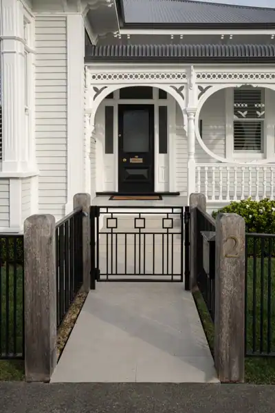 Herne Bay Villa Entrance and Heritage Architecture Front entrance of a heritage villa in Herne Bay, Auckland, showcasing traditional veranda detailing that inspires a complementary landscape design.