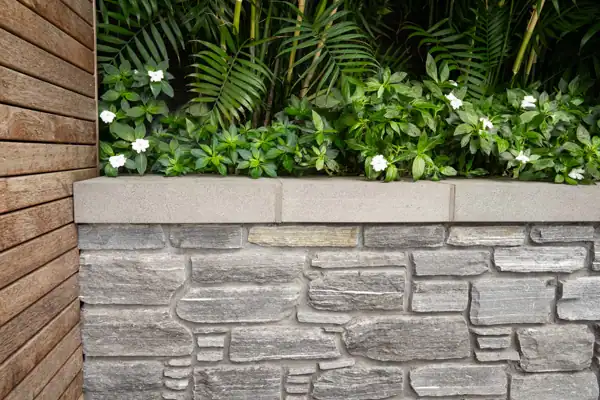 Natural Stone Retaining Wall and Layered Planting Natural stone retaining wall with layered planting, creating a timeless landscape that complements a heritage home.